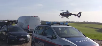 In this video grab provided by PULS 24 News TV, police vehicles and a police helicopter operate in the village of Fraunschalg near Altenfelden, Austria, Monday, Oct. 28, 2024, after people were fatally shot in the area. (PULS 24 News TV via AP)