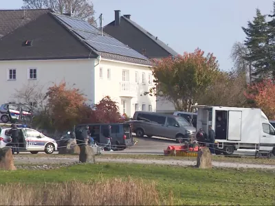 In this video grab provided by PULS 24 News TV, police vehicles and officers stand in front of a building in the village of Fraunschalg near Altenfelden, Austria, Monday, Oct. 28, 2024, after people were fatally shot in the area. (PULS 24 News TV via AP)