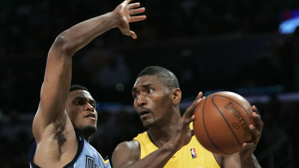 Los Angeles Lakers forward Ron Artest (37) takes the ball to the basket past Memphis Grizzlies forward Rudy Gay, left, during the second half of an NBA basketball game, Friday, Nov. 6, 2009, in Los Angeles. The Lakers won 114 to 98. (AP Photo/Lori Shepler)