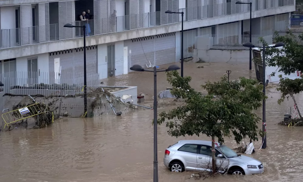 Cars are trapped by flooding in Valencia, Wednesday, Oct. 30, 2024. (AP Photo/Alberto Saiz)