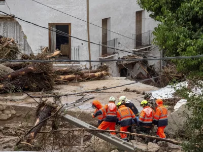 Members of emergency services carry the body of a person trapped after floods in Letur, Albacete, Tuesday, Oct. 29, 2024. (Víctor Fernández/Europa Press via AP)