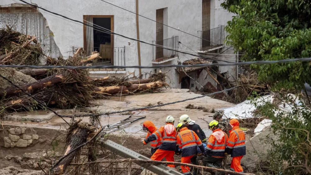 Members of emergency services carry the body of a person trapped after floods in Letur, Albacete, Tuesday, Oct. 29, 2024. (Víctor Fernández/Europa Press via AP)