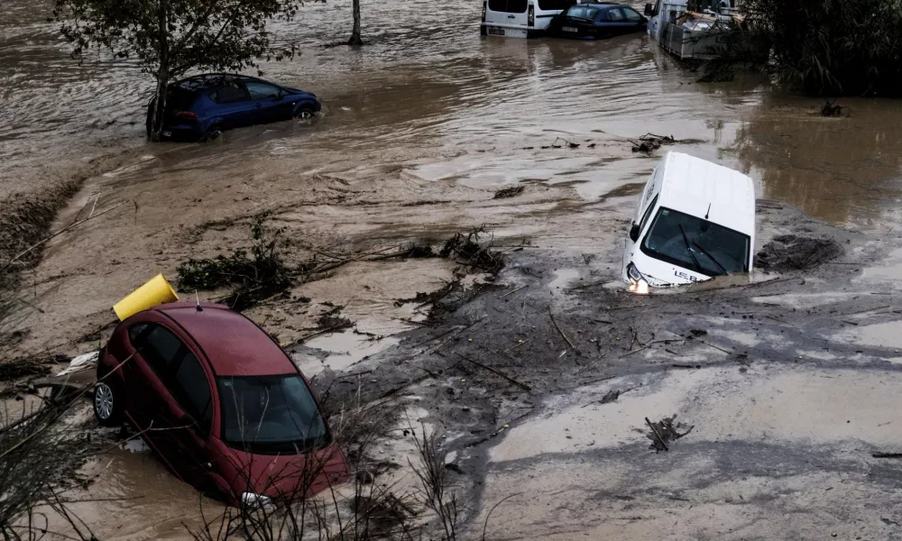 Cars are being swept away by the water, after floods preceded by heavy rains caused the river to overflow its banks in the town of Alora, Malaga, Spain, Tuesday, Oct. 29, 2024. (AP Photo/Gregorio Marrero)