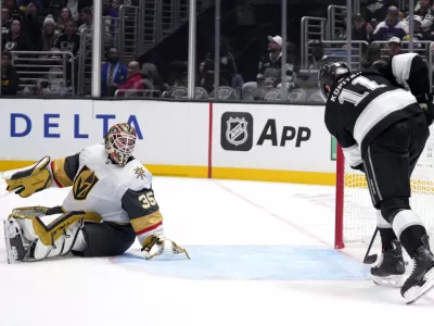 Los Angeles Kings center Anze Kopitar, right, scores on Los Angeles Kings goaltender Darcy Kuemper during the second period of an NHL hockey game, Wednesday, Oct. 30, 2024, in Los Angeles. (AP Photo/Mark J. Terrill)