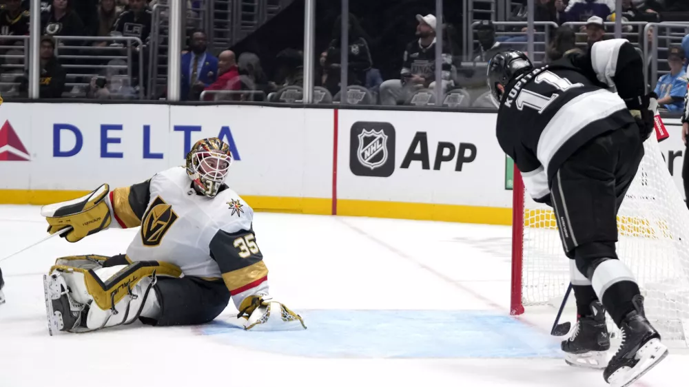 Los Angeles Kings center Anze Kopitar, right, scores on Los Angeles Kings goaltender Darcy Kuemper during the second period of an NHL hockey game, Wednesday, Oct. 30, 2024, in Los Angeles. (AP Photo/Mark J. Terrill)