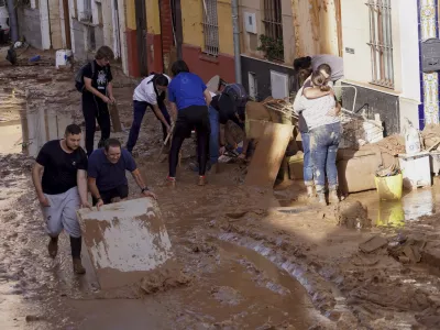 Residents clean their houses affected by floods in Valencia, Spain, Thursday, Oct. 31, 2024. (AP Photo/Alberto Saiz)