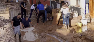 Residents clean their houses affected by floods in Valencia, Spain, Thursday, Oct. 31, 2024. (AP Photo/Alberto Saiz)