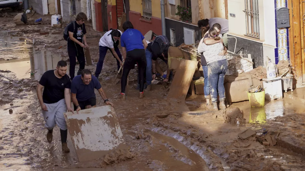 Residents clean their houses affected by floods in Valencia, Spain, Thursday, Oct. 31, 2024. (AP Photo/Alberto Saiz)