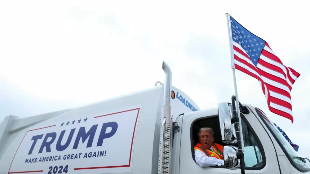 Republican presidential nominee and former U.S. President Donald Trump sits in a garbage truck, in Green Bay, Wisconsin, U.S., October 30, 2024. REUTERS/Brendan McDermid