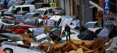 A man stands next to stranded cars, following floods in Sedavi, Valencia, Spain, October 31, 2024. REUTERS/Susana Vera   TPX IMAGES OF THE DAY