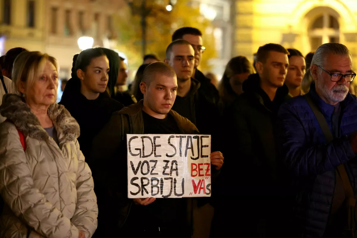 A man holds a banner that reads "Where does the train to Serbia stop without you." As people gather in front of Novi Sad city hall, following the roof of a train station collapsing, killing several people in Novi Sad, Serbia November 1, 2024. REUTERS/Zorana Jevtic