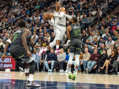 Nov 1, 2024; Minneapolis, Minnesota, USA; Denver Nuggets guard Russell Westbrook (4) shoots over Minnesota Timberwolves guard Mike Conley (10) in the fourth quarter at Target Center. Mandatory Credit: Matt Blewett-Imagn Images