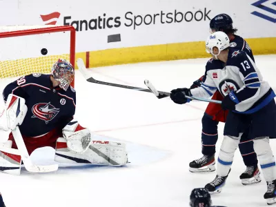 Winnipeg Jets forward Gabriel Vilardi, right, watches teammate defenseman Josh Morrissey's goal past Columbus Blue Jackets goalie Elvis Merzlikins, left, and defenseman Ivan Provorov during the third period of an NHL hockey game in Columbus, Ohio, Friday, Nov. 1, 2024. The Jets won 6-2. (AP Photo/Paul Vernon)