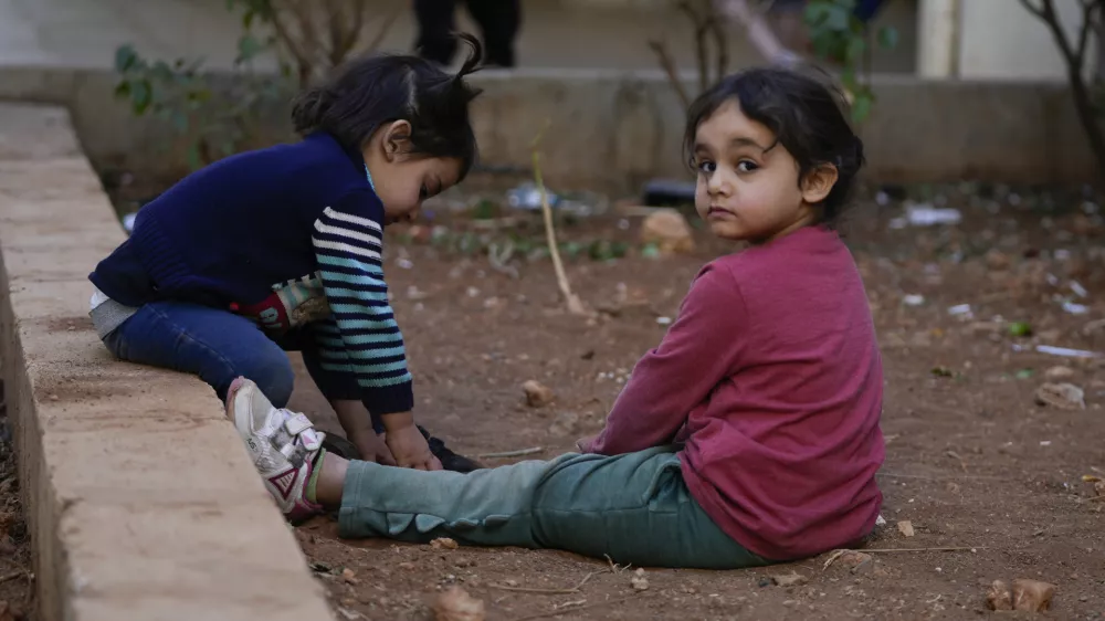 Displaced children, who fled Baalbek city and the nearby towns of Douris and Ain Bourday with their families amid the ongoing Hezbollah-Israel war, play inside a school being used as a shelter, in Deir Al-Ahmar, east Lebanon, Thursday, Oct. 31, 2024. (AP Photo/Hassan Ammar)