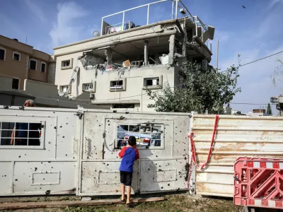 A boy looks through the gate to a house that was hit, following a projectiles attack from Lebanon towards Israel, amid cross-border hostilities between Hezbollah and Israel, in the central Israeli town of Tira, November 2, 2024. REUTERS/Moti Milrod ISRAEL OUT. NO COMMERCIAL OR EDITORIAL SALES IN ISRAEL