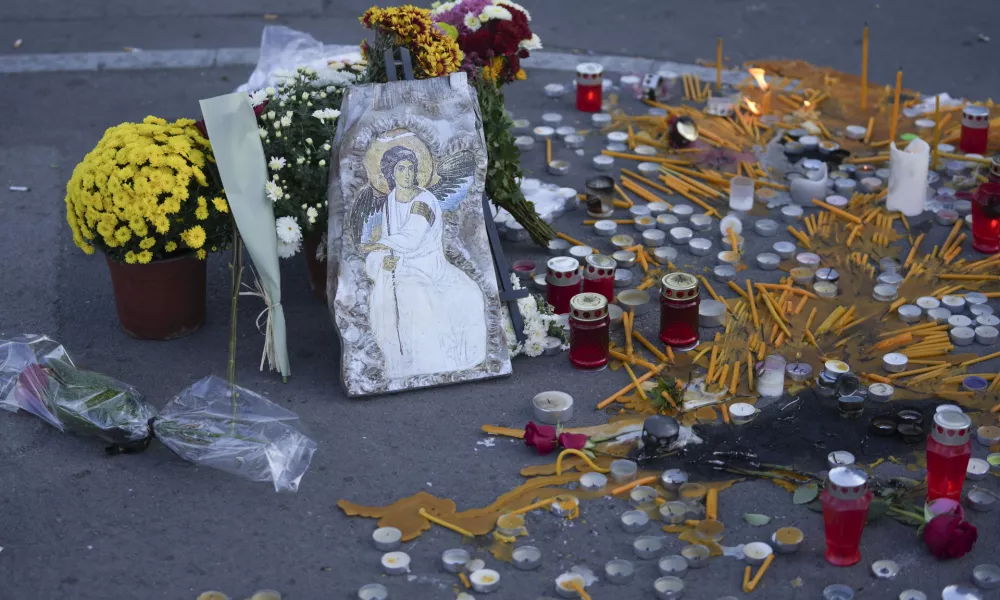 An Orthodox icon and candles left at the site for the victims after an outdoor roof collapsed at a train station on Friday, in Novi Sad, Serbia, Saturday, Nov. 2 2024. (AP Photo/Darko Vojinovic)