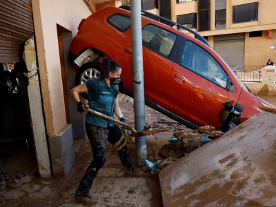 A Spanish Civil Guard who came from Teruel as a volunteer helps remove mud from a home in the aftermath of floods caused by heavy rains, in Alfafar, near Valencia, Spain, November 2, 2024. REUTERS/Susana Vera REFILE - QUALITY REPEAT