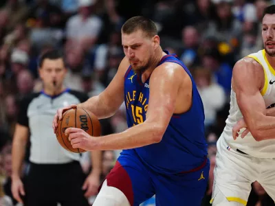 Nov 2, 2024; Denver, Colorado, USA; Denver Nuggets center Nikola Jokic (15) controls the ball past Utah Jazz forward Kyle Filipowski (22) in the second half at Ball Arena. Mandatory Credit: Ron Chenoy-Imagn Images