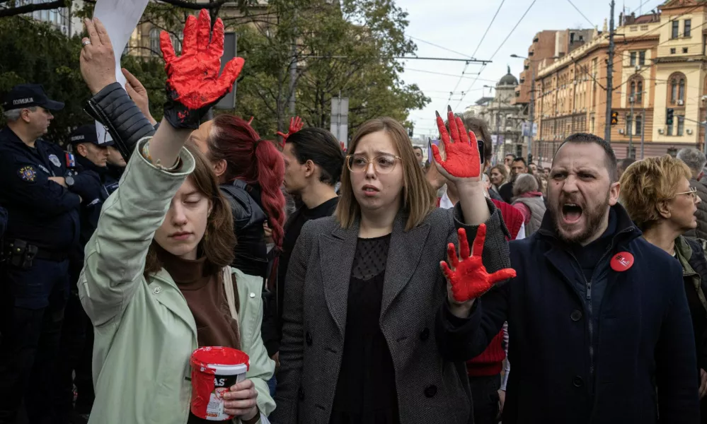 Demonstrators show their hands painted in red as they protest to commemorate an accident at a railway station in the Serbian city of Novi Sad, for which they blame negligence and corruption by the authorities, in front of the government in Belgrade, Serbia November 3, 2024. REUTERS/Marko Djurica