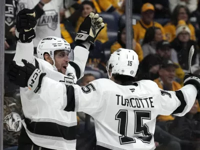 Los Angeles Kings center Anze Kopitar, left, celebrates with Alex Turcotte (15) after scoring against the Nashville Predators during the first period of an NHL hockey game Monday, Nov. 4, 2024, in Nashville, Tenn. (AP Photo/Mark Humphrey)