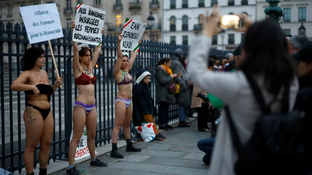 Women in underwear hold placards in support of an Iranian female student, named as Ahoo Daryaei on social media, seen in her underwear at a Tehran university in protest against country's strict Islamic dress code, and all Iranian women who fight for freedom, during a rally in front of the Pantheon in Paris, France, November 5, 2024. The slogans read "Alliance of Women for Democracy", "To the rebellious Iranian women, grateful women" and "Woman, Life, Freedom". REUTERS/Stephanie Lecocq