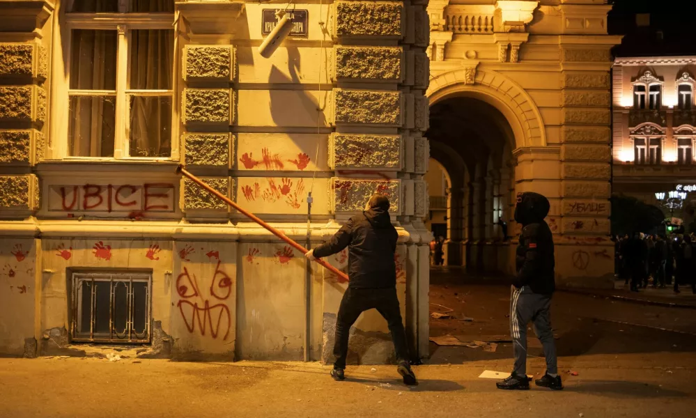 A demonstrator destroys a surveillance camera during a protest over an accident at a railway station in the Serbian city of Novi Sad, for which they blame negligence and corruption by the authorities, in front of the city hall of Novi Sad, Serbia November 5, 2024. REUTERS/Marko Djurica