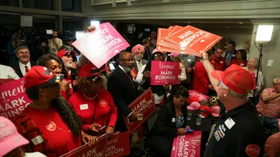 Supporters of Republican candidate for governor of North Carolina Mark Robinson hold up signs, following results on Election Day during the 2024 U.S. presidential election, at the Raleigh City Club in Raleigh, North Carolina, U.S., November 5, 2024. REUTERS/Sam Wolfe