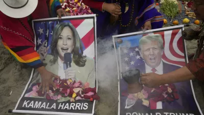 Shamans perform a good luck ritual holding posters of Democratic presidential nominee Vice President Kamala Harris and Republican presidential nominee former President Donald Trump, at the beach in Lima, Peru, Tuesday, Nov. 5, 2024. (AP Photo/Martin Mejia)