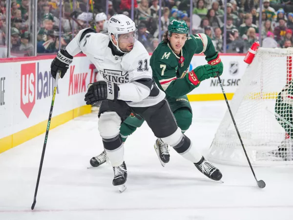 Nov 5, 2024; Saint Paul, Minnesota, USA; Los Angeles Kings center Anze Kopitar (11) skates after the puck against the Minnesota Wild defenseman Brock Faber (7) in the first period at Xcel Energy Center. Mandatory Credit: Brad Rempel-Imagn Images