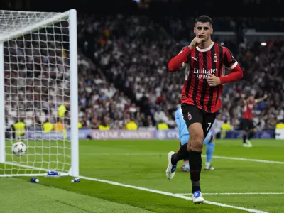 AC Milan's Alvaro Morata celebrates after scoring his side's 2nd goal against Real Madrid during the Champions League opening phase soccer match at the Santiago Bernabeu stadium in Madrid, Spain, Tuesday, Nov. 5, 2024. (AP Photo/Manu Fernandez)