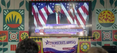 A screen shows live footage of Republican presidential nominee former President Donald Trump speech during a news program in Nairobi, Kenya, Wednesday, Nov. 6, 2024. (AP Photo/Brian Inganga)