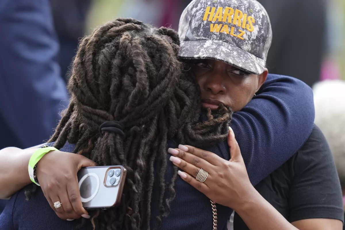 Supporters of Vice President Kamala Harris embrace as they wait for her to deliver a concession speech for the 2024 presidential election, Wednesday, Nov. 6, 2024, on the campus of Howard University in Washington. (AP Photo/Stephanie Scarbrough)