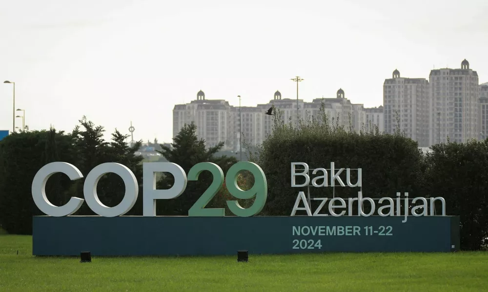 FILE PHOTO: A view shows a sign of the COP29 United Nations Climate Change Conference with a backdrop of the cityscape in Baku, Azerbaijan October 31, 2024. REUTERS/Aziz Karimov/File Photo