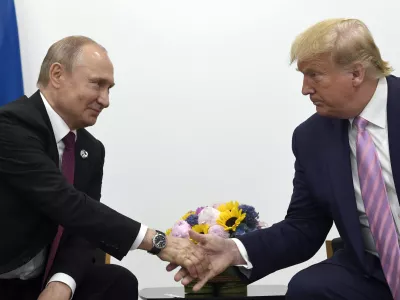 FILE - In this June 28, 2019, file photo, President Donald Trump, right, shakes hands with Russian President Vladimir Putin, left, during a bilateral meeting on the sidelines of the G-20 summit in Osaka, Japan. (AP Photo/Susan Walsh, File)