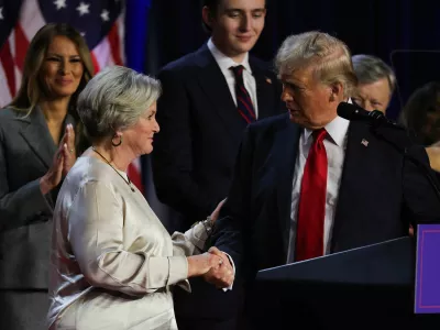 Republican presidential nominee and former U.S. President Donald Trump shakes hands with his senior advisor Susie Wiles as he speaks, following early results from the 2024 U.S. presidential election in Palm Beach County Convention Center, in West Palm Beach, Florida, U.S., November 6, 2024. REUTERS/Carlos Barria