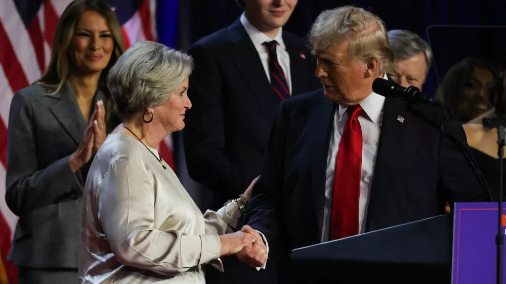 Republican presidential nominee and former U.S. President Donald Trump shakes hands with his senior advisor Susie Wiles as he speaks, following early results from the 2024 U.S. presidential election in Palm Beach County Convention Center, in West Palm Beach, Florida, U.S., November 6, 2024. REUTERS/Carlos Barria