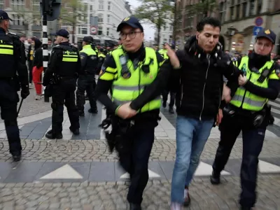 A person is detained by the police as Israeli Maccabi Tel Aviv supporters demonstrate in Amsterdam, Netherlands, November 7, 2024, in this screengrab obtained from a social media video. Michel Van Bergen/via REUTERS THIS IMAGE HAS BEEN SUPPLIED BY A THIRD PARTY. MANDATORY CREDIT.