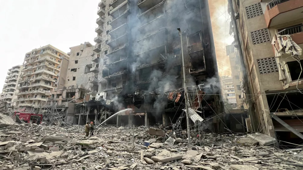 Firefighters work at a damaged site, in the aftermath of Israeli strikes, amid the ongoing hostilities between Hezbollah and Israeli forces, in Beirut's southern suburbs, Lebanon, November 9, 2024. REUTERS/Haider Kadhim   TPX IMAGES OF THE DAY