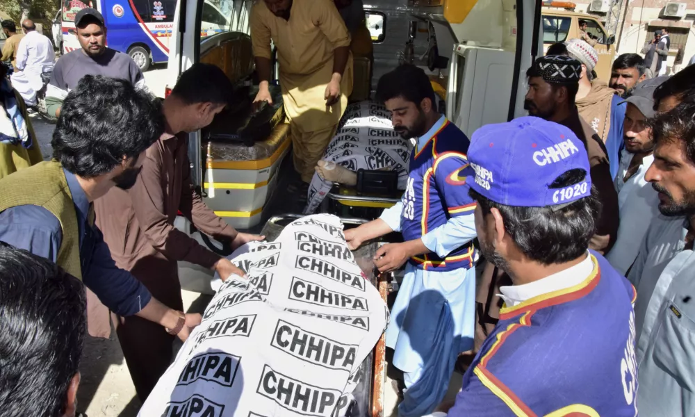 Volunteers and relatives load bodies of victims of a bomb explosion at railway station, into an ambulance after receiving from a hospital, in Quetta, southwestern Pakistan, Saturday, Nov. 9, 2024. (AP Photo/Arshad Butt)