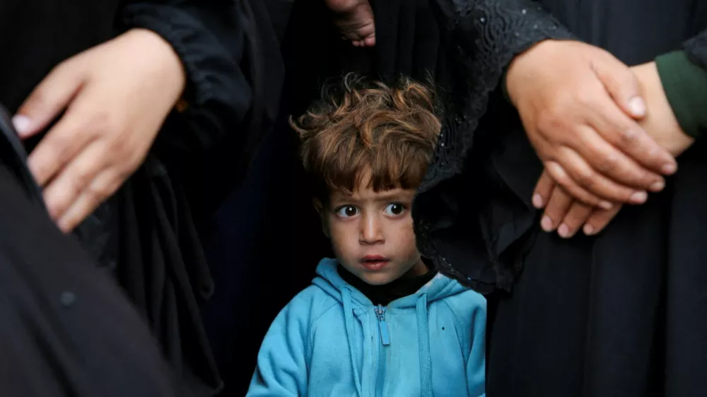 A child looks on as people mourn Palestinians killed in Israeli strikes, at Nasser hospital in Khan Younis in the southern Gaza Strip November 9, 2024. REUTERS/Hatem Khaled   TPX IMAGES OF THE DAY