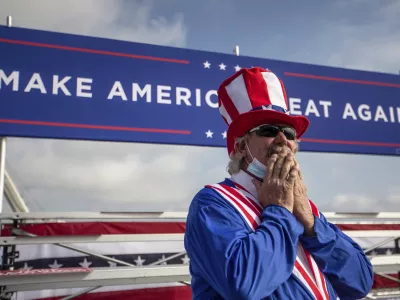 ﻿Phil Eason wears an Uncle Sam costume during the Make America Great Again Victory rally with Vice President Mike Pence at the Piedmont Triad International Airport in Greensboro, N.C., on Tuesday, Oct. 27, 2020. (Khadejeh Nikouyeh/News & Record via AP)