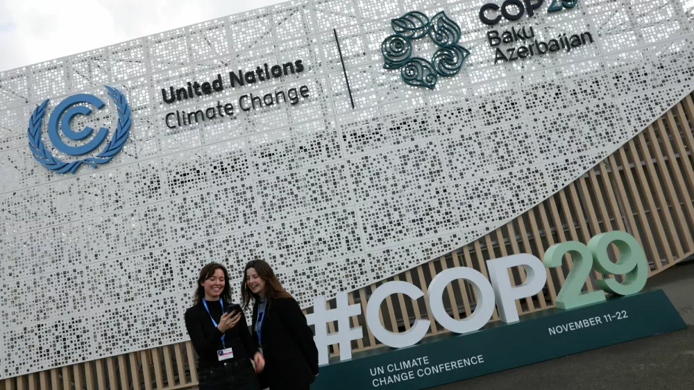 Kiki Ritmeijer and Sarah Nasrawi, both U.N. Youth Representative on Sustainable Development from the Netherlands, pose for a selfie outside the venue ahead of the United Nations climate change conference, known as COP29, in Baku, Azerbaijan November 10, 2024. REUTERS/Murad Sezer