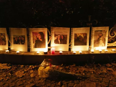 Photos showing Mackenzie Michalski, an 31-year-old American tourist who was murdered while on vacation, hang at a candlelight vigil in Budapest, Hungary, Saturday, Nov. 9, 2024. (AP Photo/Bela Szandelszky)