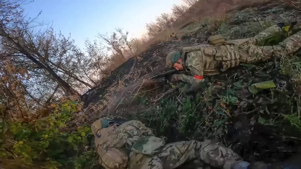 In this image taken from a video released by the Russian Defense Ministry on Thursday, Nov. 7, 2024, Russian Army soldiers fight with Ukrainian Armed forces in the Sudzhansky district of the Kursk region of Russia. (Russian Defense Ministry Press Service via AP)