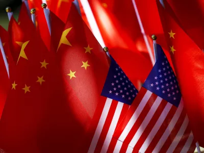 ﻿In this Sept. 16, 2018, photo, American flags are displayed together with Chinese flags on top of a trishaw in Beijing. The American Chamber of Commerce in China says Beijing will "dig its heels in" after U.S. tariff hikes and appealed for a negotiated end to their trade battle. The chamber on Tuesday, Sept. 18 warned a "downward spiral" appears certain after President Donald Trump approved a tariff hike on 0 billion of Chinese imports in a dispute over Beijing's technology policy. (AP Photo/Andy Wong)