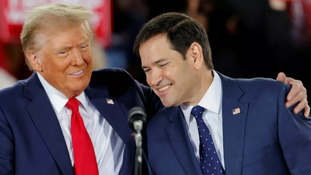 Republican presidential nominee and former U.S. President Donald Trump and Senator Marco Rubio (R-FL) react during a campaign event at Dorton Arena, in Raleigh, North Carolina, U.S. November 4, 2024. REUTERS/Jonathan Drake