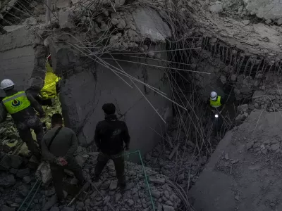 Rescue workers search for victims at a house hit in an Israeli airstrike in Baalchmay village east of Beirut, Lebanon, Tuesday, Nov. 12, 2024. (AP Photo/Hassan Ammar)