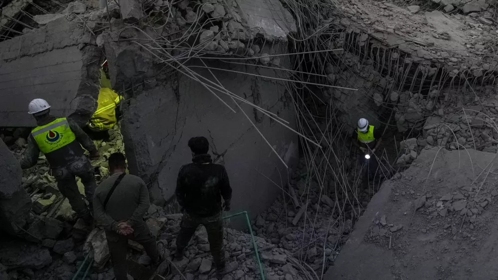 Rescue workers search for victims at a house hit in an Israeli airstrike in Baalchmay village east of Beirut, Lebanon, Tuesday, Nov. 12, 2024. (AP Photo/Hassan Ammar)