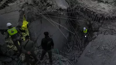 Rescue workers search for victims at a house hit in an Israeli airstrike in Baalchmay village east of Beirut, Lebanon, Tuesday, Nov. 12, 2024. (AP Photo/Hassan Ammar)