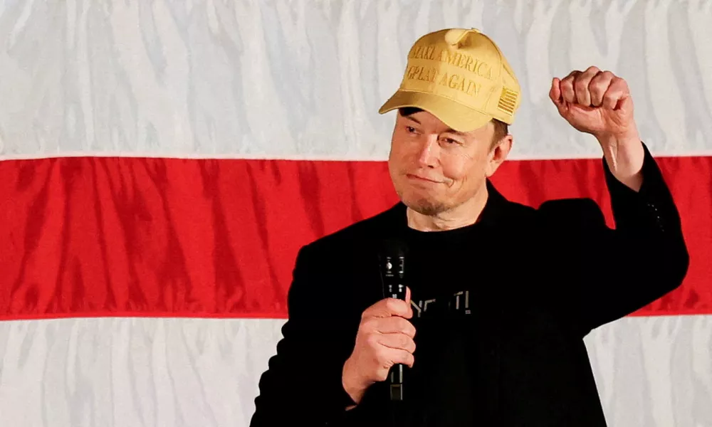 FILE PHOTO: Tesla CEO and X owner Elon Musk, who supports Republican presidential nominee former U.S. President Donald Trump, gestures as he speaks about voting during an America PAC Town Hall in Folsom, Pennsylvania, U.S., October 17, 2024. REUTERS/Rachel Wisniewski/File Photo